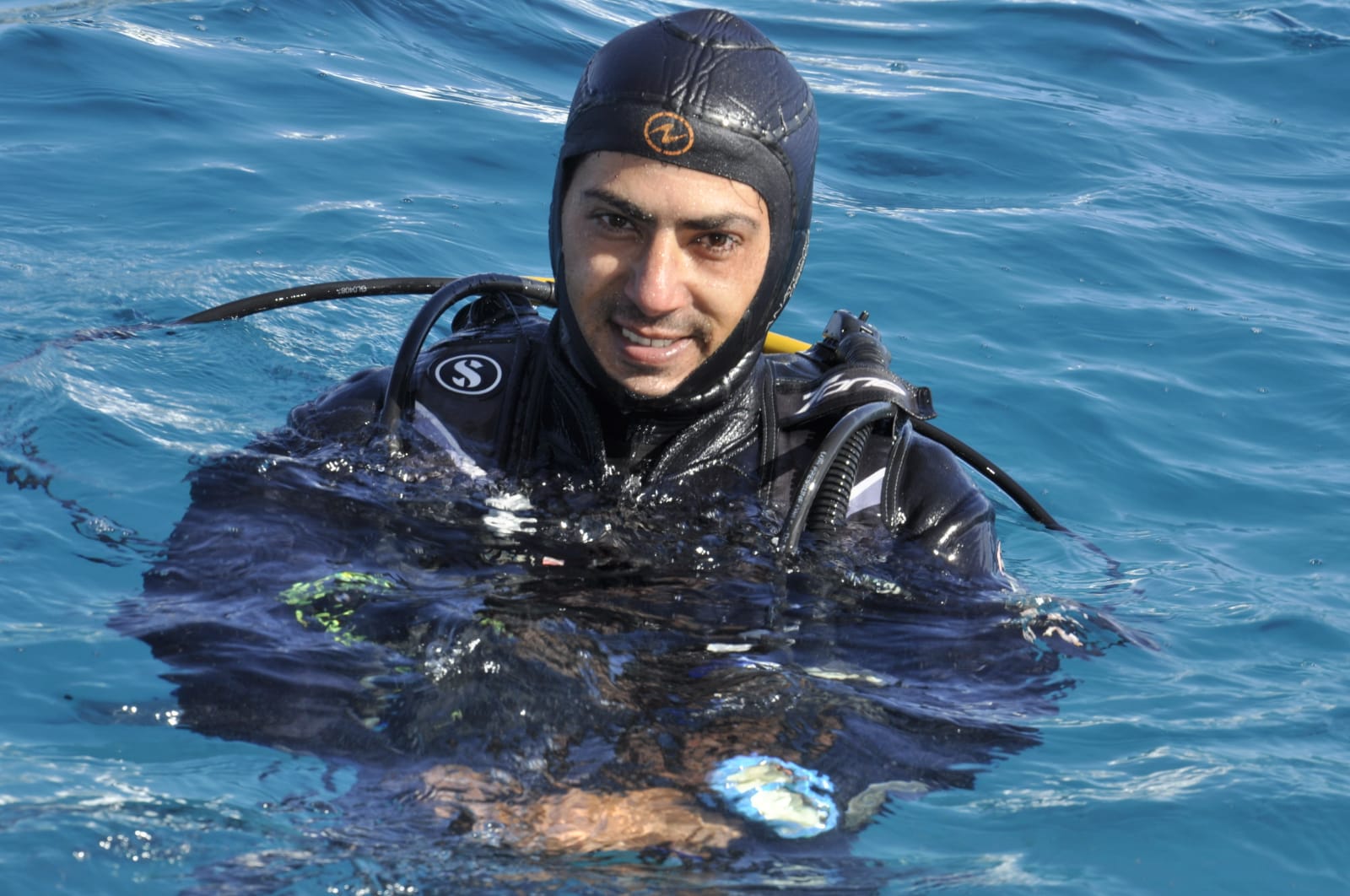 Instructor ABU smiling at the surface in his diving equipment